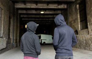 Two people in hoodies in an industrial area